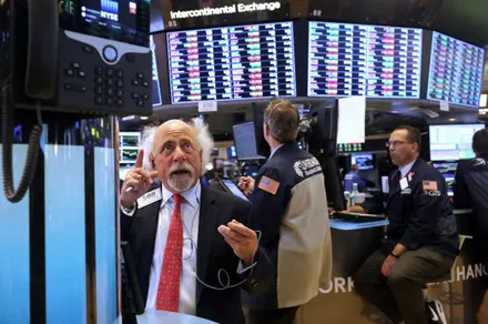 Stock trader reacts passionately on the trading floor amid market fluctuations.