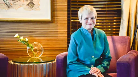 Smiling person sitting in a modern room.