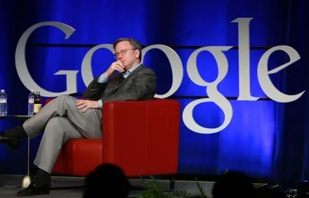 Man seated on stage with Google logo.